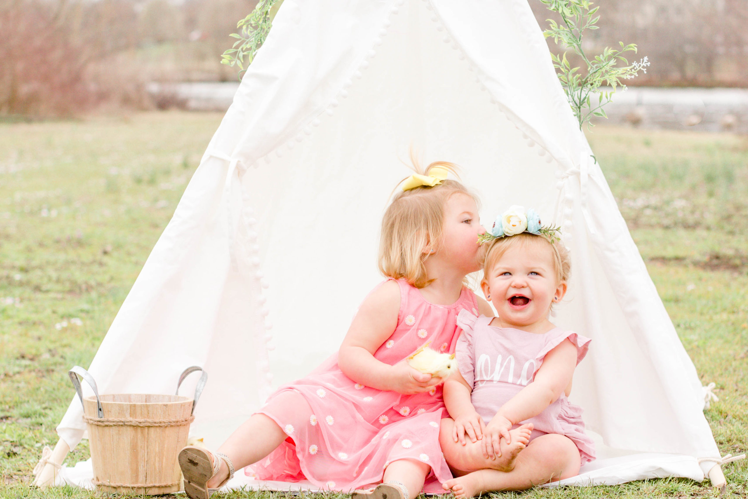 2 sisters in a white Easter tent in the park during Hendersonville Nashville TN Spring Family Mini Session by Jenny Macy Photography