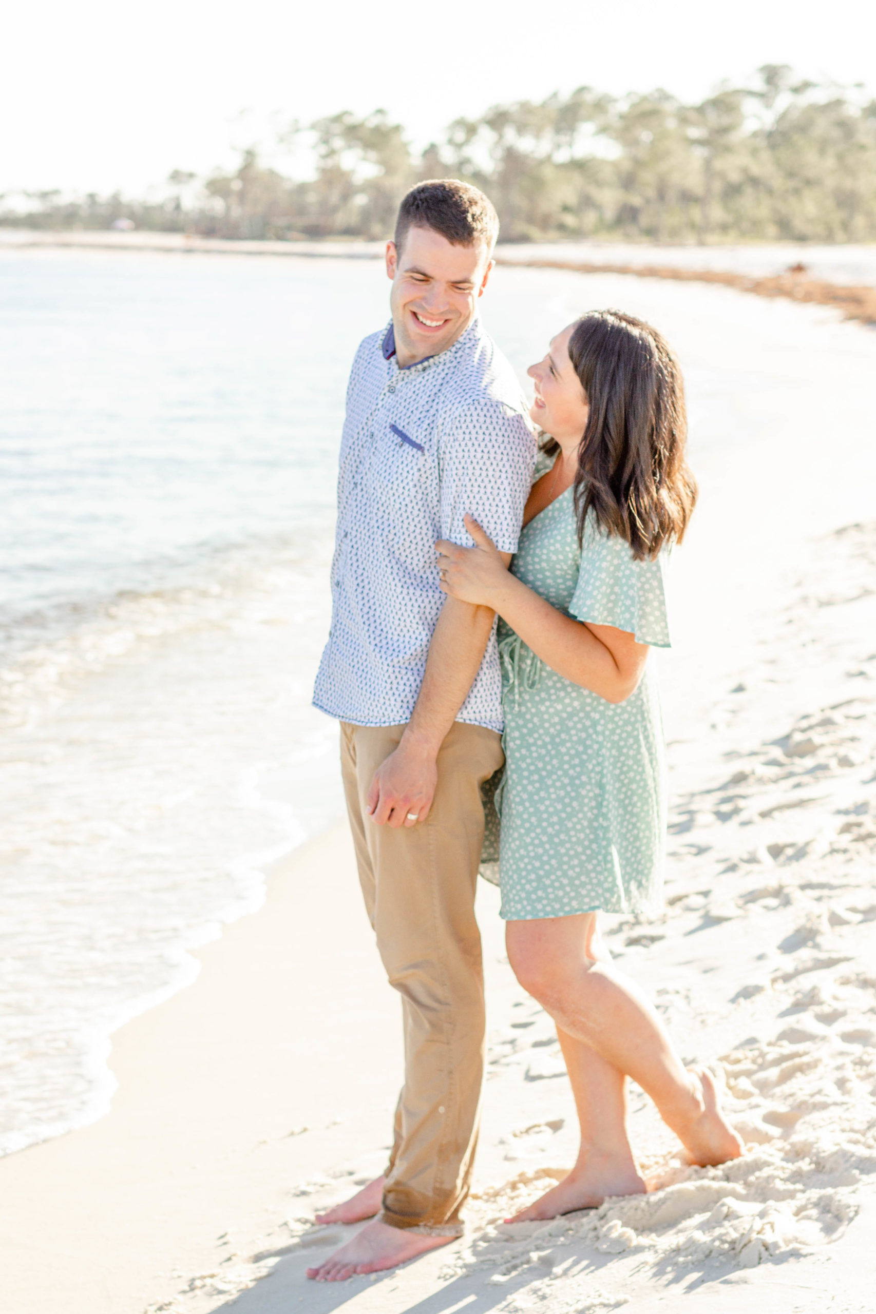A couple on the beach before sunset in Pensacola, FL during a family beach mini photo session by Jenny Macy Photography