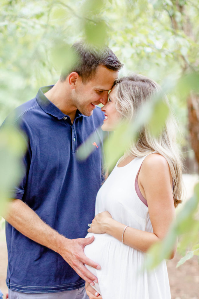 A couple in a park in Greenville SC during a family and maternity session by Jenny Macy Photography.