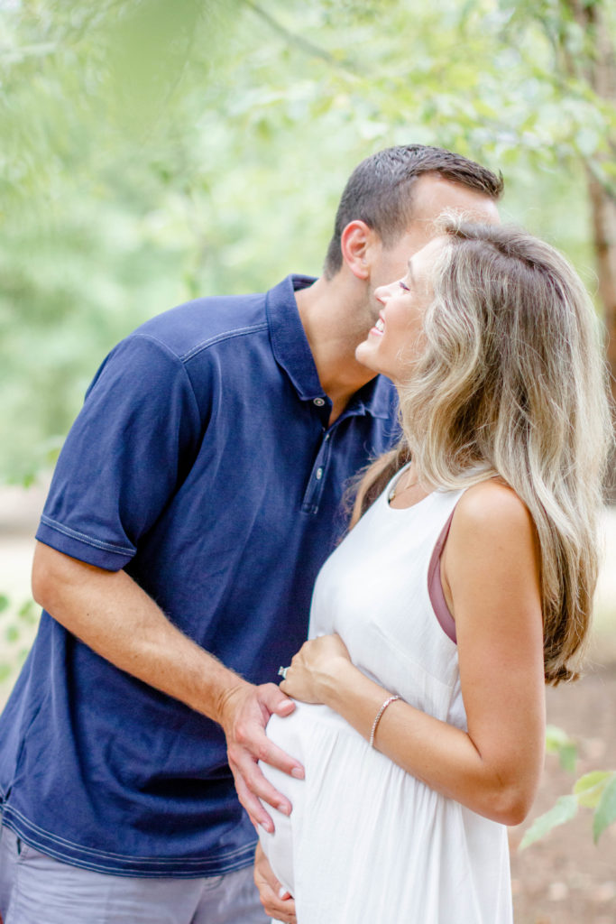 A couple in a park in Greenville SC during a family and maternity session by Jenny Macy Photography.