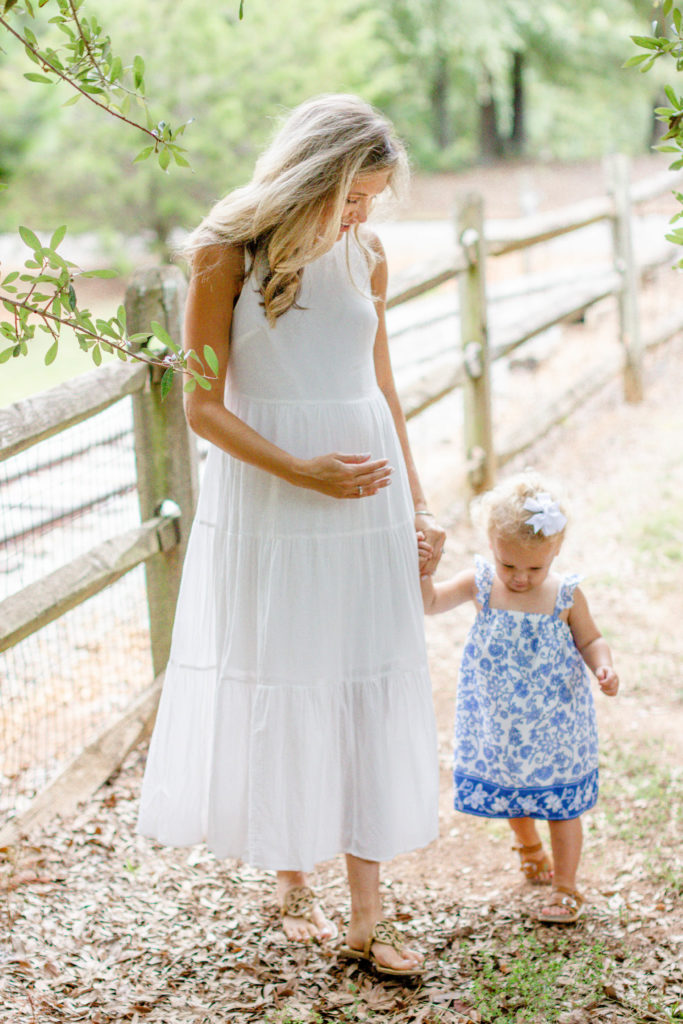 A mom with her daughter in a park in Greenville SC during a family and maternity session by Jenny Macy Photography.