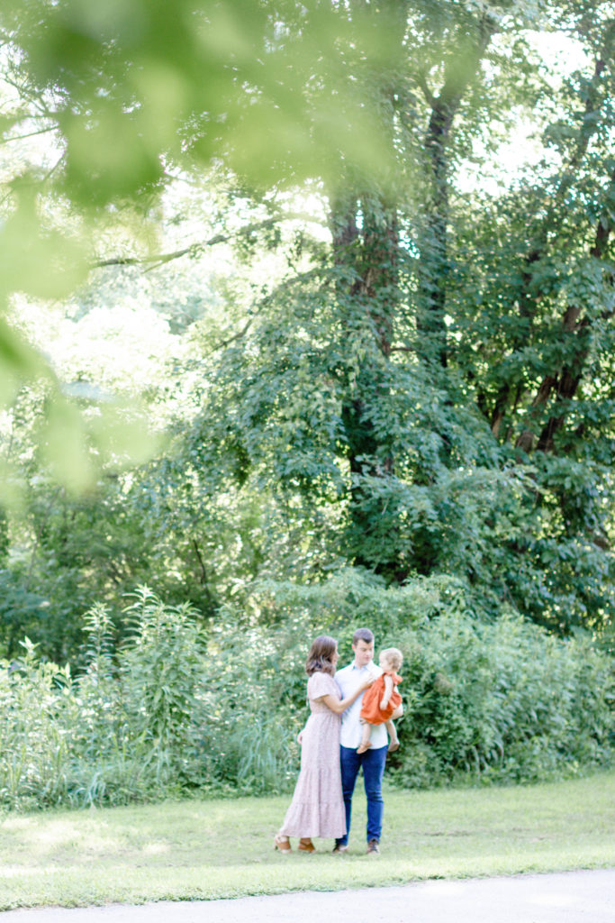 A family under the trees during a Greenville SC Family Mini Session Maternity Session by Greenville family photographer Jenny Macy Photography