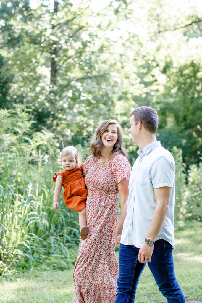 A family walking through Falls Park with their baby during a Greenville SC Family Mini Session Maternity Session by Greenville family photographer Jenny Macy Photography