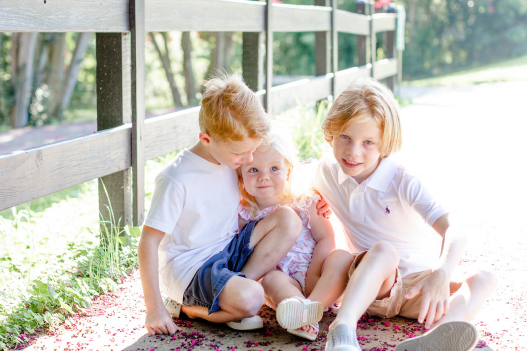 Kids sitting on the sidewalk in Greenville, SC during a family session by Jenny Macy Photography.