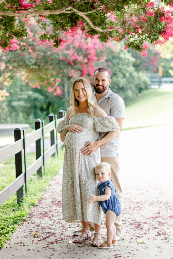 A family laughing during a maternity mini session in Greenville, SC by Jenny Macy Photography.