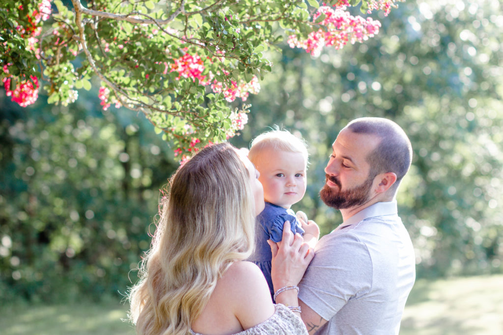 A family giving kisses during a maternity and family mini session in Greenville, SC by Jenny Macy Photography.
