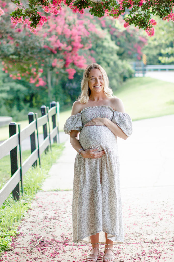A mom laughing during a maternity mini session in Greenville, SC by Jenny Macy Photography.
