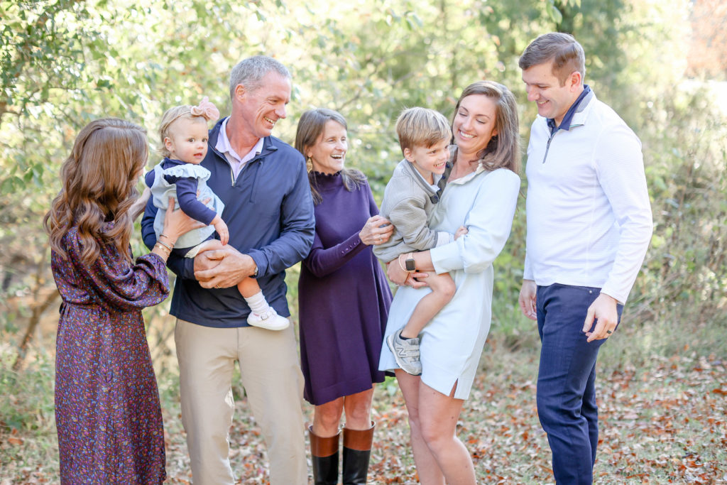 An extended family laughing during a fall family photo session in Greenville, SC with Jenny Macy Photography.