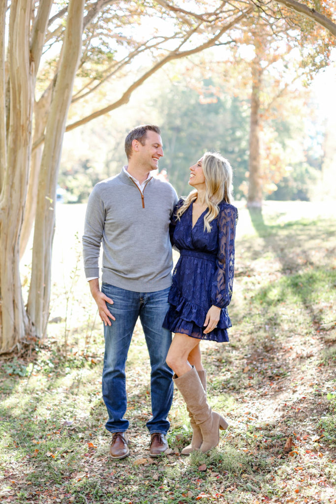 A mom and dad laughing during a fall family session in Greenville, SC by Jenny Macy Photography.