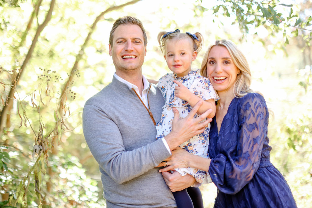 A family of 3 laughing during a fall family session in Greenville, SC by Jenny Macy Photography.