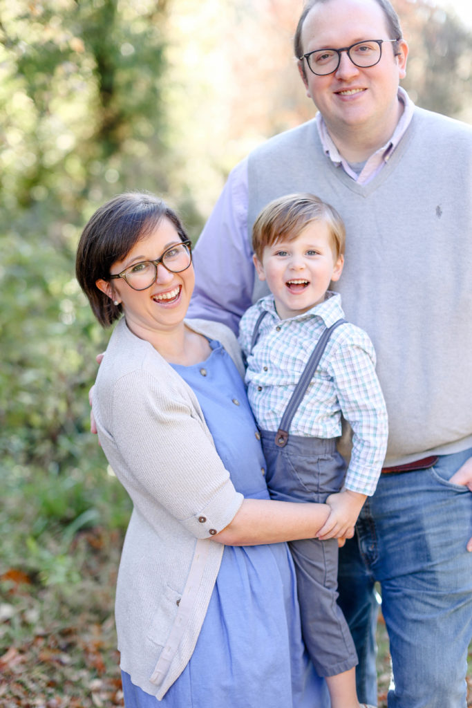 A little boy between his parents during a fall mini session in Greenville, SC with Jenny Macy Photography.