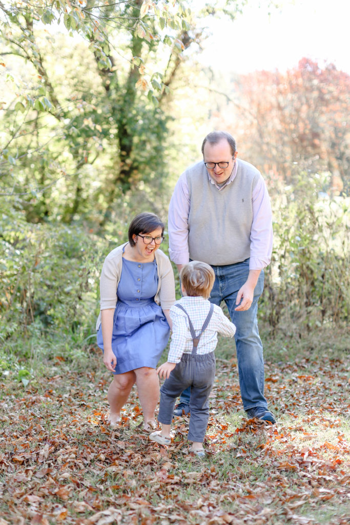 A little boy running to his parents during a fall mini session in Greenville, SC with Jenny Macy Photography.