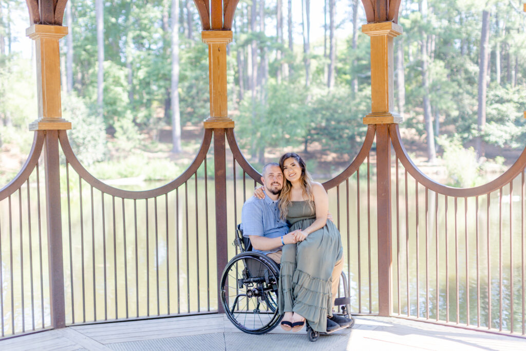 A wheelchair friendly engagement photo of a couple in a gazebo during a session with Jenny Macy Photography at Clemson Botanical Gardens in Greenville SC
